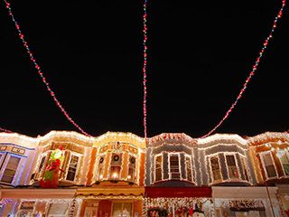 Christmas lights adorn the row houses